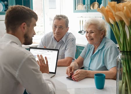 Elderly couple talking to an insurance agent